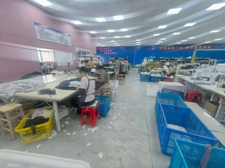 Workers at sewing stations in our factory